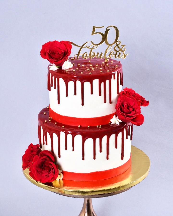 Elegant white and red cake with gum paste roses.